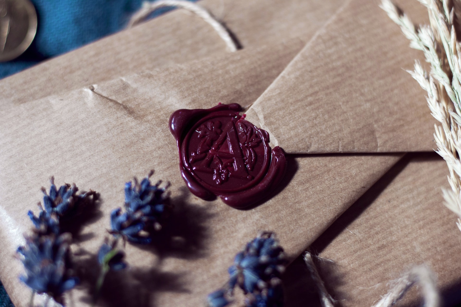 Wax seal on a natural paper envelope with flowers on top