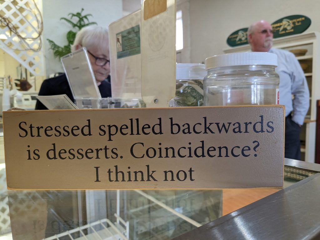 A sign on a bakery counter reads, "Stressed spelled backwards is desserts. Coincidence? I think not"