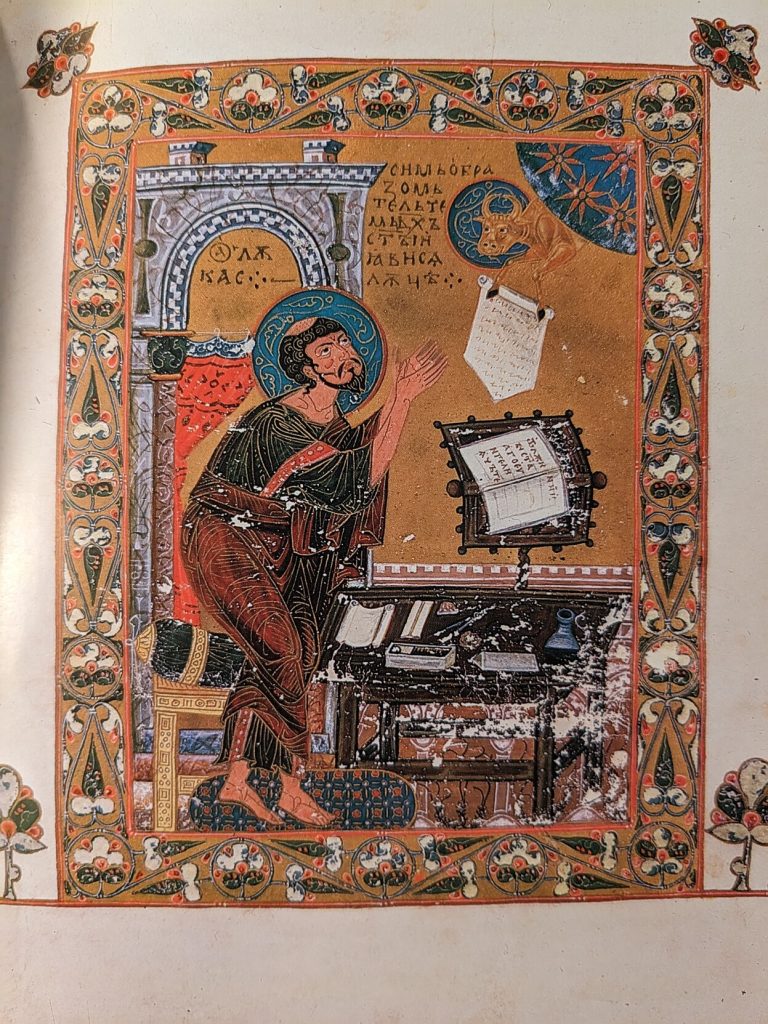 Russian illuminated manuscript from 11th century Kyiv, wherein St Luke appears to have to go really really bad and a naughty bull leans in from the corner dangling a piece of paper in front of his face
