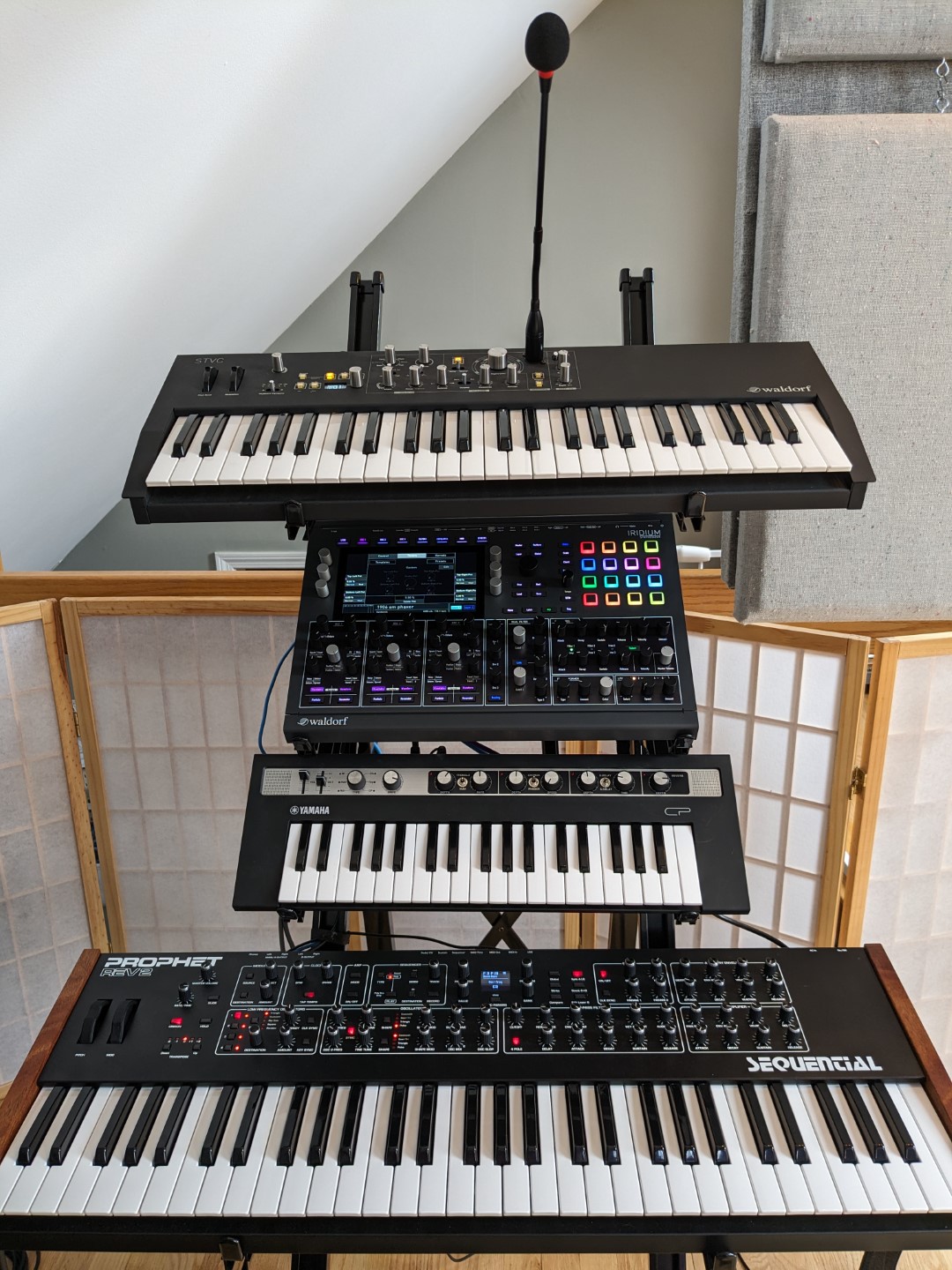 A tall stand full of synthesizers